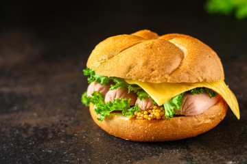 burger with sausages, cf, lettuce, tomato sauce (snack sandwich, kaiser bun). top food background. copy space