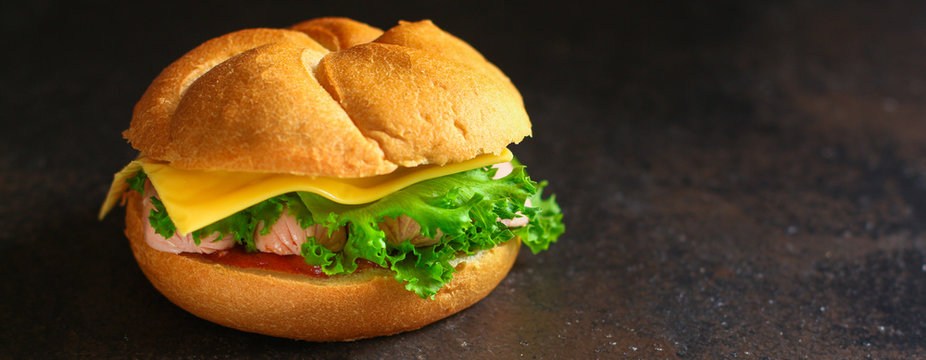 burger with sausages, cf, lettuce, tomato sauce (snack sandwich, kaiser bun). top food background. copy space