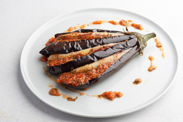 baked eggplant with filling on a white plate