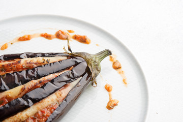 baked eggplant with filling on a white plate