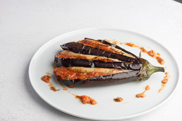 baked eggplant with filling on a white plate
