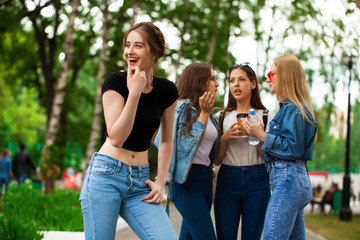 Four schoolgirls in summer park