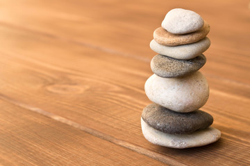 Fototapeta na wymiar Balance the stones on the wooden table.