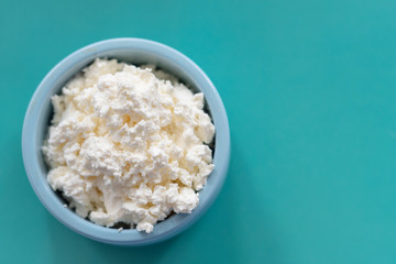 fresh cottage cheese in a blue bowl