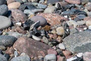 Multi coloured pebbles on a beach
