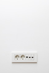 Wall in modern appartment with plugs for cable TV, internet, network and electricity
