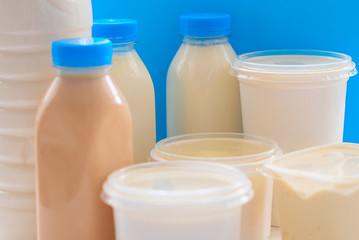 different milk products on blue background