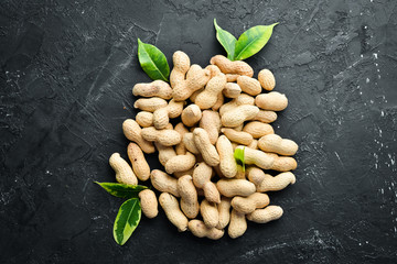 Peanuts on a black background. Nuts Top view. Free space for your text.