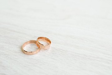 Wedding rings on white wooden background with copy space. concept of love and marriage