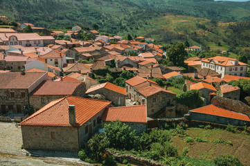 Fototapeta na wymiar Hilly landscape with the roofs from village