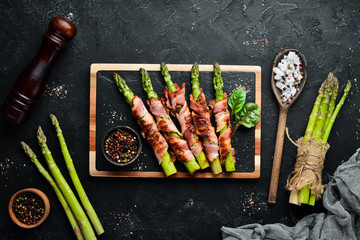 Asparagus baked with bacon and spices. Healthy food. Top view. Free space for your text.