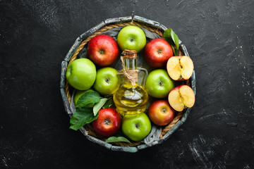 Apples and apple vinegar on the old background. Fruits. Top view. Free space for text.