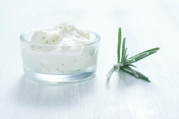 lavender cream in glass pot on white wooden table background