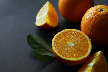 Orange citrus fruit on a stone table. Orange background.
