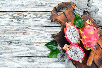 Fruit dragon on a white wooden background. Pitahaya Tropical Fruits. Top view. Free space for text.
