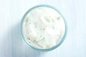 lavender cream in glass pot on white wooden table background