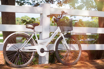 Fototapeta na wymiar white bicycle beautiful at park in the evening