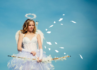 Valentines day. Little angel girl against sunny sky. Valentines day card. Happy teenage angel girl....