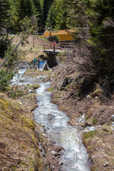 View of waterfalls and mountain streams with a lot of melt water in spring in the swiss alps