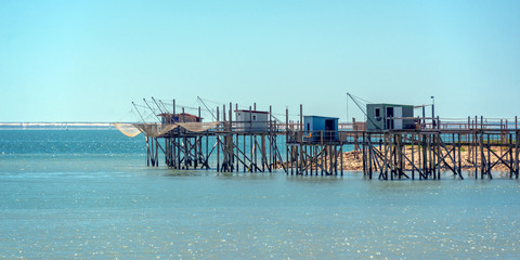 Typical old wooden fishing huts on stilts in the atlantic ocean near La Rochelle, France