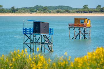 Typical and colorful wooden fishing huts on stilts in the atlantic ocean near La Rochelle, France
