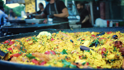 Outside chef preparing paella street food festival wok shrimp fried rice