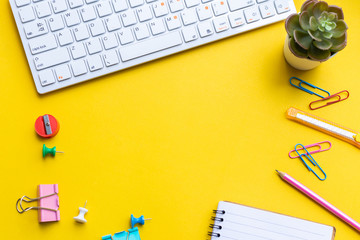 equipment and empty notebook with on yellow background.
