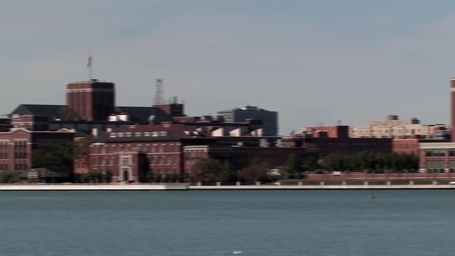 Pan shot from Rivertown Warehouse District to 
UAW-GM Center for Human Resources at Detroit's River Front, USA.