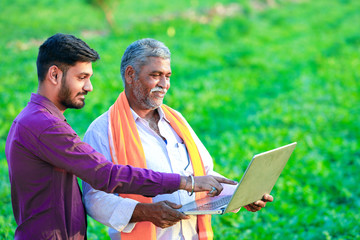 indian agronomist with farmer at field