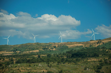 Wind turbines for electric power generation on hill