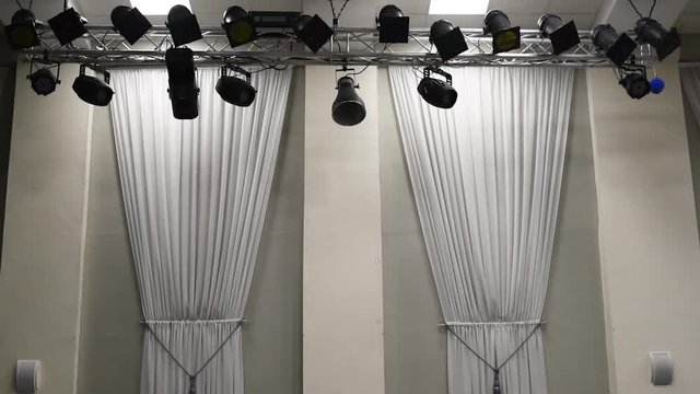 Theatrical lighting mounted on the wall creates a muffled light.Stage lighting is fixed on the ceiling to illuminate objects, light rays and colored light 
