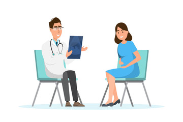 Doctor showing ultrasound sheet to pregnant woman at the hospital