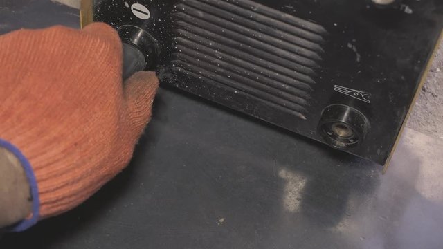 Connection of wires to the welding machine, the hand connects the wires before welding. Power cable