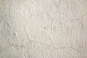Abstract background. White lime wall with fine cracks.