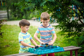 Two boys playing with a spinning top kid toy. Popular children game