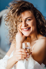 Portrait of happy smiling charming woman with glass of champagne.