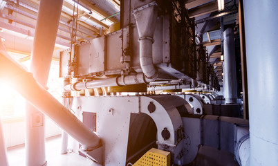 Interior of modern natural oil factory. The piping, pumps and motors