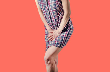 Young woman pressed her hands to the lower abdomen. Medical concept. Gynecological problems
