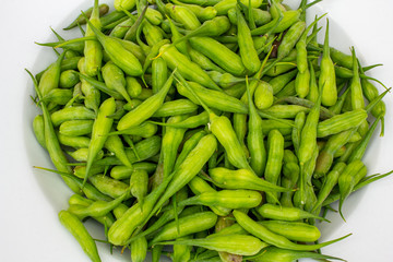 Radish seed pods on a white plate.