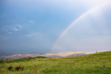 Wonderful landscape view over Basilicata countryside on a stormy day with a rainbow. Monteserico castle, Italy