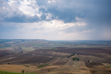 Fototapeta premium Wonderful landscape view over Basilicata countryside on a cloudy day. Monteserico castle, Italy