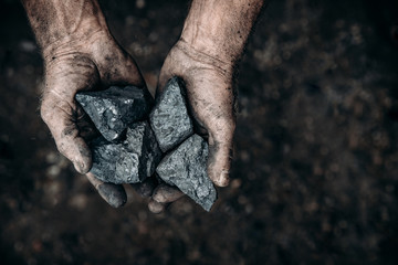 Coal in miner holds. Concept industry mining