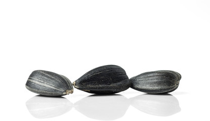 Three sunflower seeds close up. Isolated on the white background.