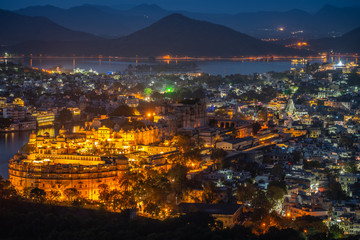 Fototapeta premium Aerial view of City Palace after sunset. Udaipur, Rajasthan, India