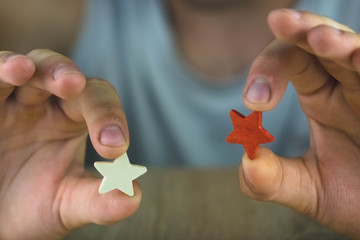 a man holding a red and white star