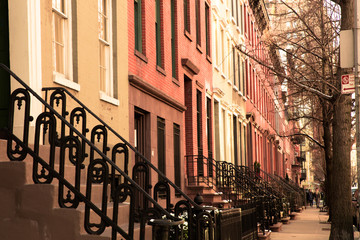 Row of lovely brick and brownstone New York City apartments seen from outside.