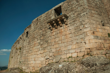 Balcony in gothic style on a wall made of stone bricks