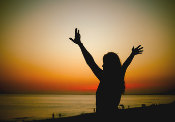 Fototapeta premium hands up at sea sunset