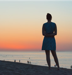 woman posing at sea sunset