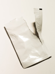 White paper sachet torn